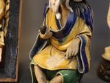 three figurines of a man with a hat and a hat on
