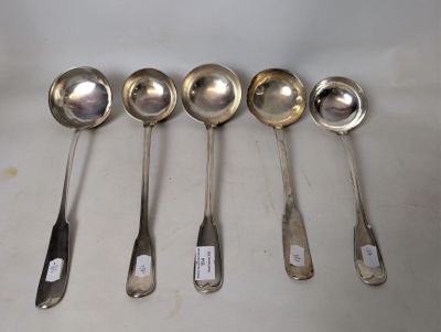 six spoons are lined up in a row on a table