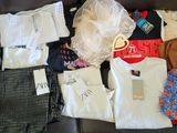 a lot of clothes that are sitting on a couch