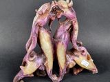 two figurines that are sitting on a black surface