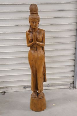 wooden statue of a woman holding a baby in her arms