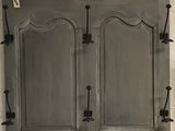 a picture of a cabinet with a mirror on the wall
