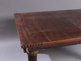 an old wooden table with two leaves on the top of it