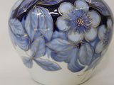 a blue and white vase with blue flowers on it