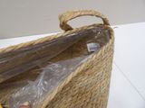 a basket with a handle that has a plastic bag inside of it