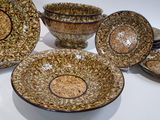 many bowls and plates that are sitting on a table