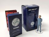 a figurine of a man standing next to a box of books