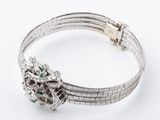 a close up of a bracelet on a white surface