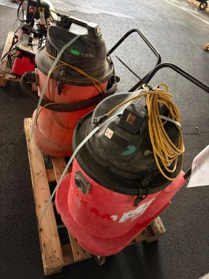 two air compressors sitting on a pallet on the street