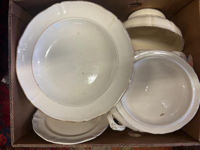 a box full of white plates and bowls in it