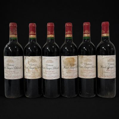 six bottles of wine lined up in a row on a black background