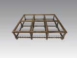 an old wooden bed frame with beads on the sides