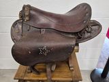 une selle de cheval posée sur un tabouret en bois