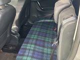the back seats of a car are covered in a tartant