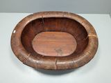 a wooden bowl that is sitting on a table
