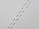 a white gold necklace with a diamond pendant on a silver chain