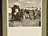 an old black and white photo of a group of people in a field