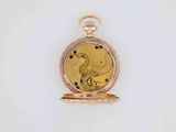 an old gold pocket watch with a bird on it ' s face