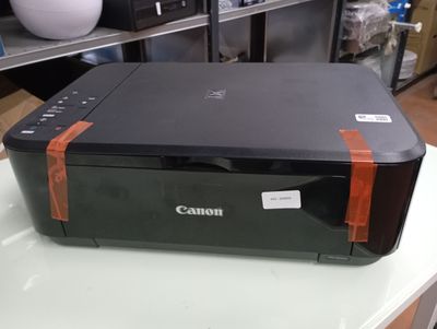 a canon printer sitting on a table in a room