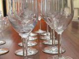 several empty wine glasses sitting on top of a wooden table