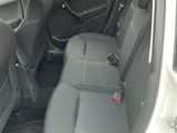 the back seats of a car with the door open and the driver ' s seat down