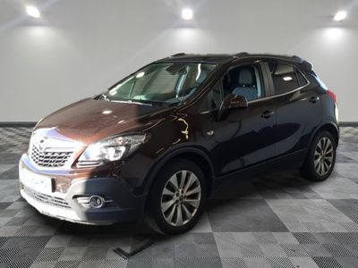 the brown buick suv is parked on a checkered tile floor