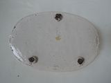 a white plate with holes in it on a table