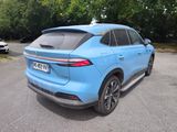 the rear end of a blue suv parked in a parking lot
