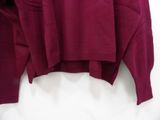 maroon long sleeved sweater with pockets on a hanger
