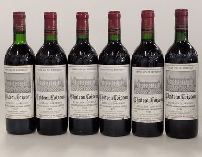 six bottles of wine are lined up on a table