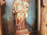 a statue of a woman holding a child inside of a glass case