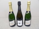 three bottles of champagne sitting next to each other on a table