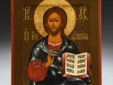 an icon of jesus holding a book in his hands