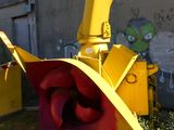 a yellow and red machine that is sitting in the grass