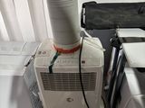 a white air conditioner sitting on top of a white box