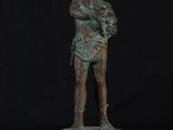 a bronze statue of a woman holding a baby in her arms