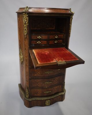 une armoire ancienne en bois avec un plateau en velours rouge