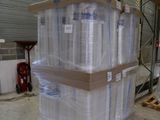 a large stack of pallets with clear plastic wrap on them