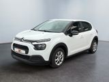 a white citrole parked in a room with a black floor