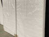 a close up of a wall with a white sheet covering it