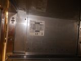 a metal door with a sticker on it in a room