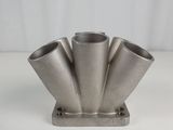 a close up of a metal object on a white surface