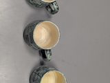 three cups of coffee are lined up on a gray surface