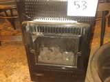 a stove that is sitting in a room with chairs