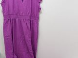 purple dress and t - shirt on hanger next to white wall