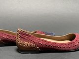 pair of women ' s shoes on a gray surface with a gray background