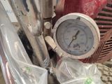 a close up of a pressure gauge on a red fire hydrant