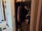 a closet with clothes and clothes hanging in it