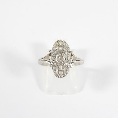 a close up of a diamond ring on a white surface