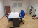 a white table with blue chairs in the middle of a room